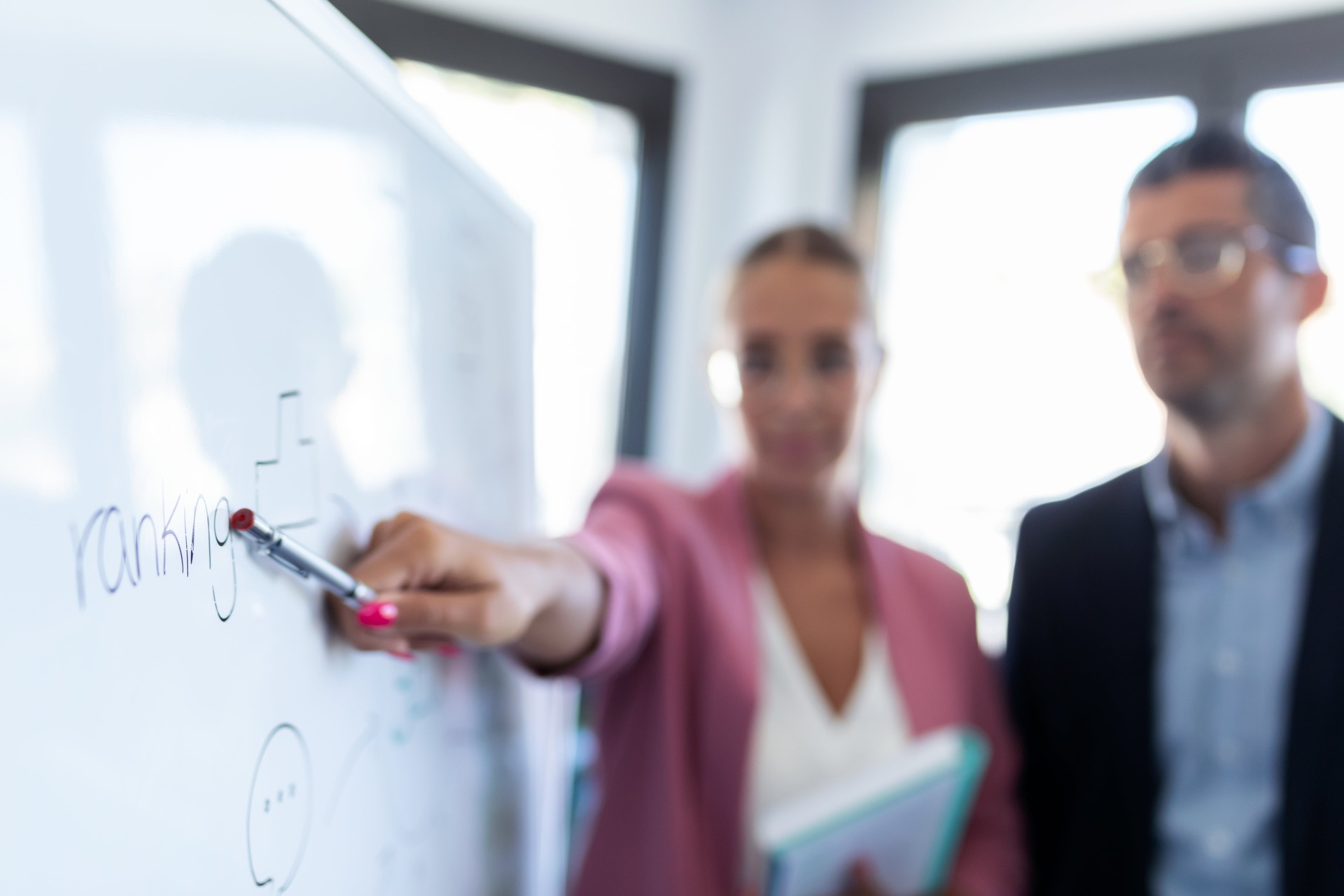 English teacher pointing at whiteboard