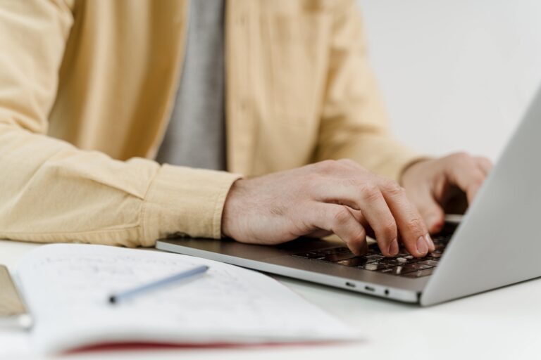 Man working on a document during an online course