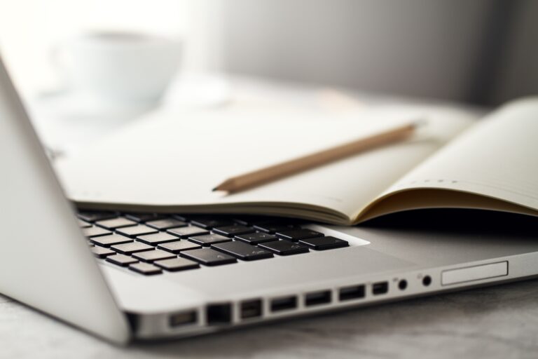 Notes held above a laptop keyboard
