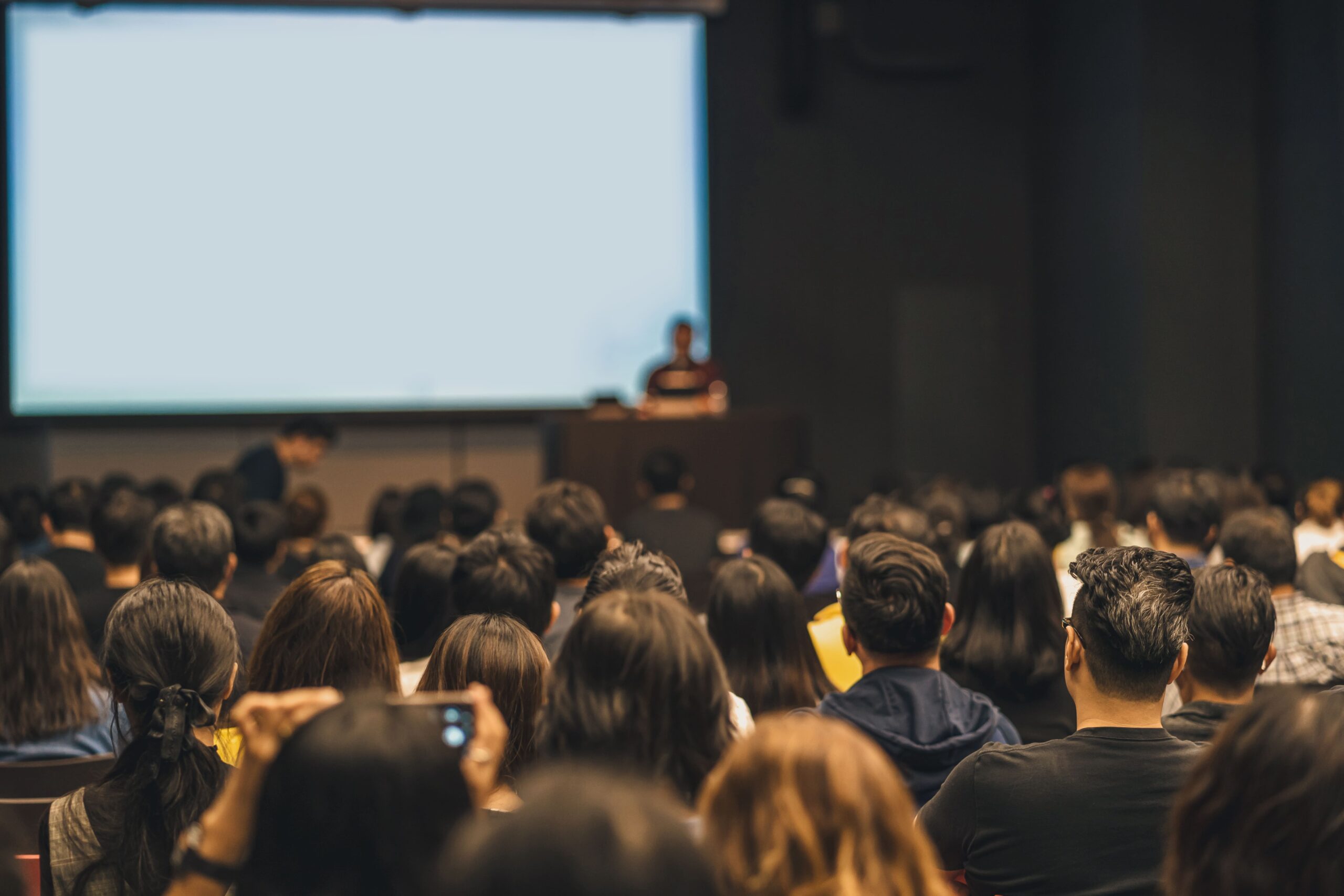 Audience watching a speaker at a conference