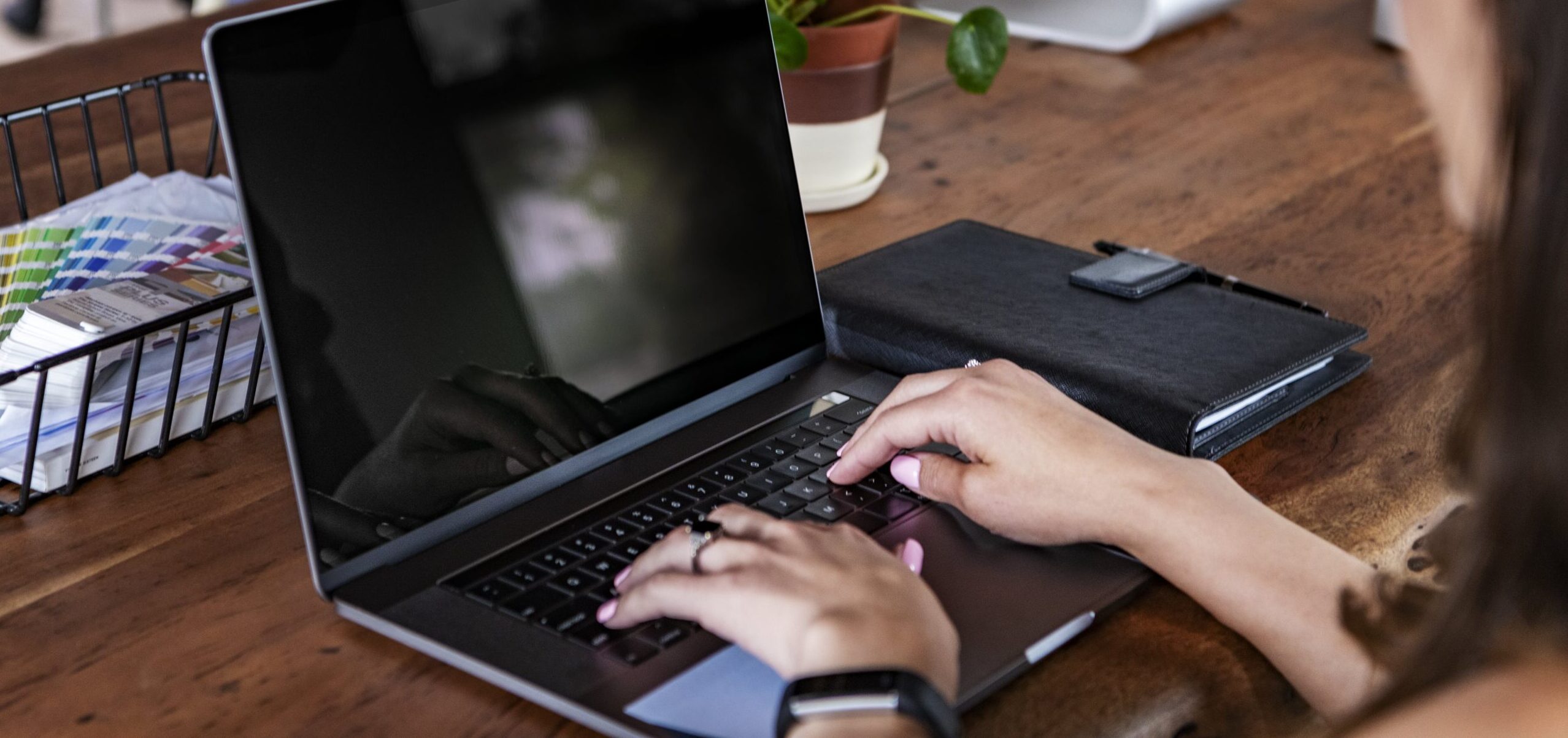 Woman writing an email at her desk