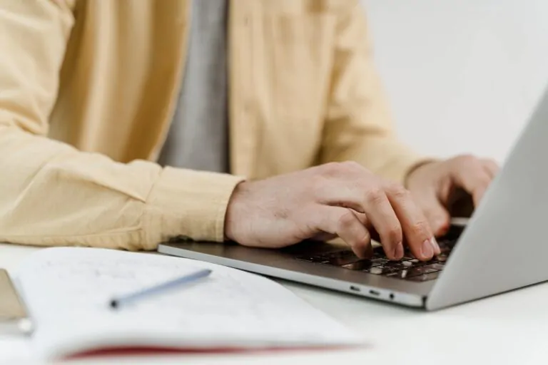Man working on a document during an online course