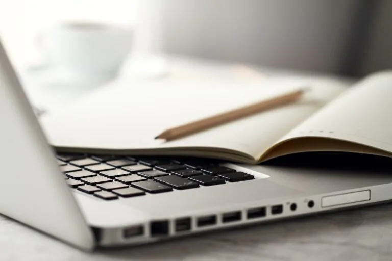Notes held above a laptop keyboard